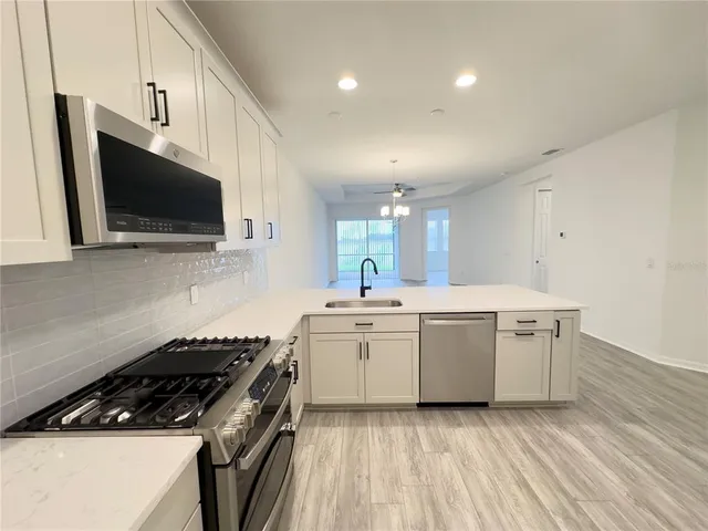 a kitchen with a stove and a microwave