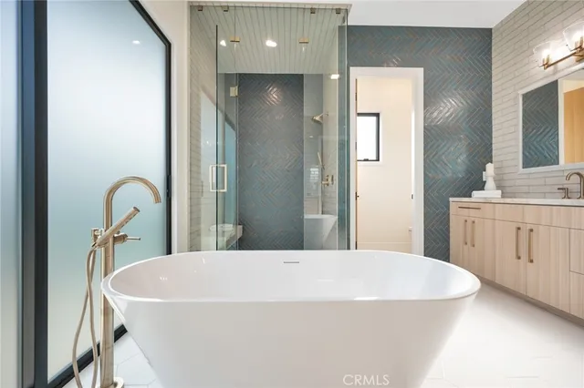 a spacious bathroom with a tub and sink