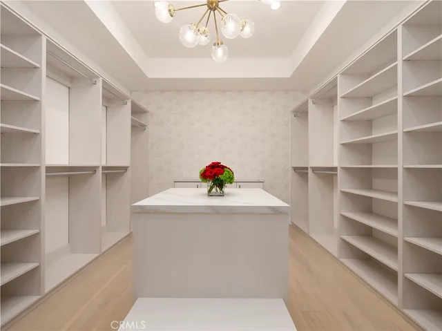 a kitchen with white cabinets and sink