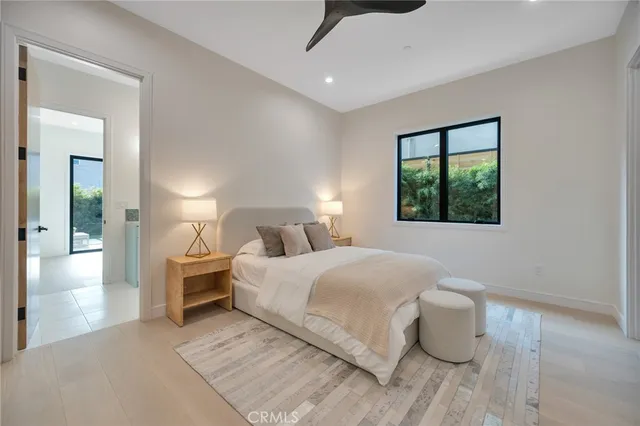 a bedroom with a large bed and a window