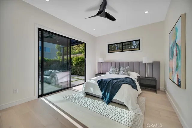 a living room with furniture kitchen view and a wooden floor