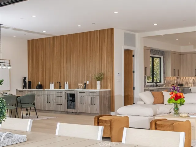 a kitchen with kitchen island granite countertop a sink cabinets and stainless steel appliances