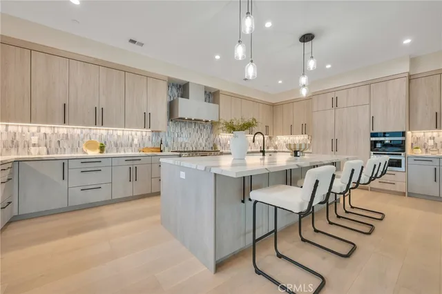 a living room with furniture and a view of kitchen