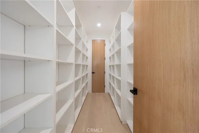 a room with a table chair and a large window