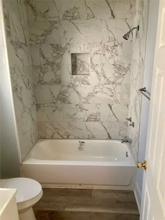 a bathroom with a bathtub and a toilet