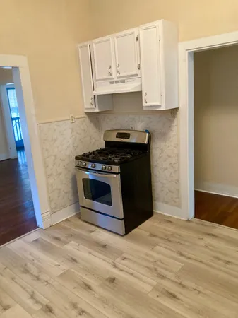 a kitchen with stainless steel appliances granite countertop a stove a microwave and a refrigerator