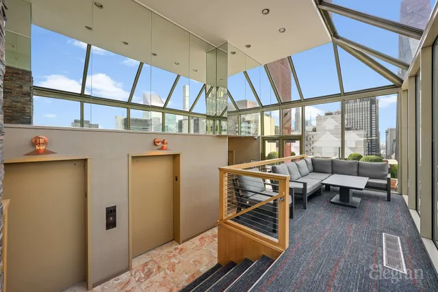 a terrace with outdoor seating and city view