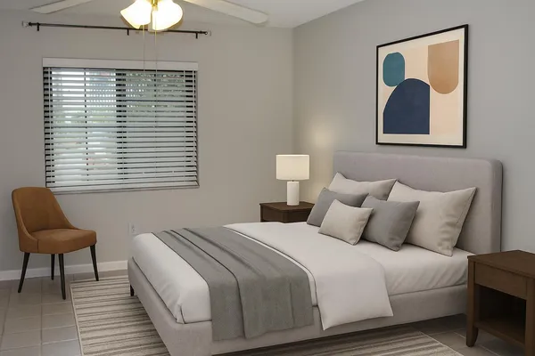 a bedroom with a bed and a window