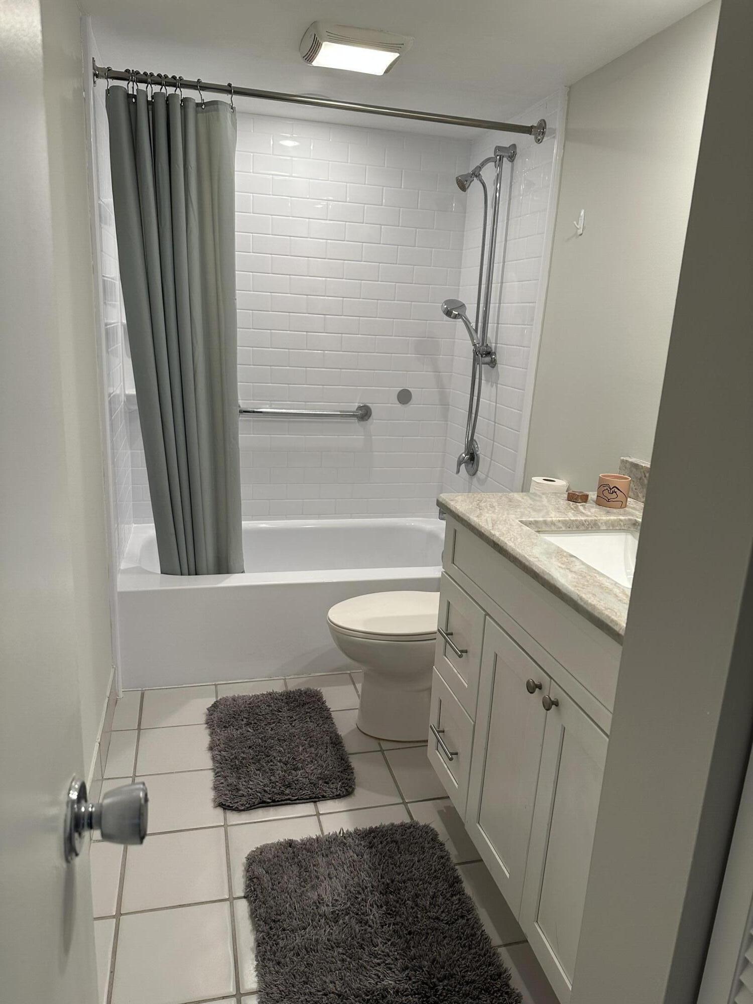 950 South Kanner Highway, Unit D4 Stuart, FL 34994 - Photo 13 of 36 a bathroom with a sink a toilet a mirror and shower
