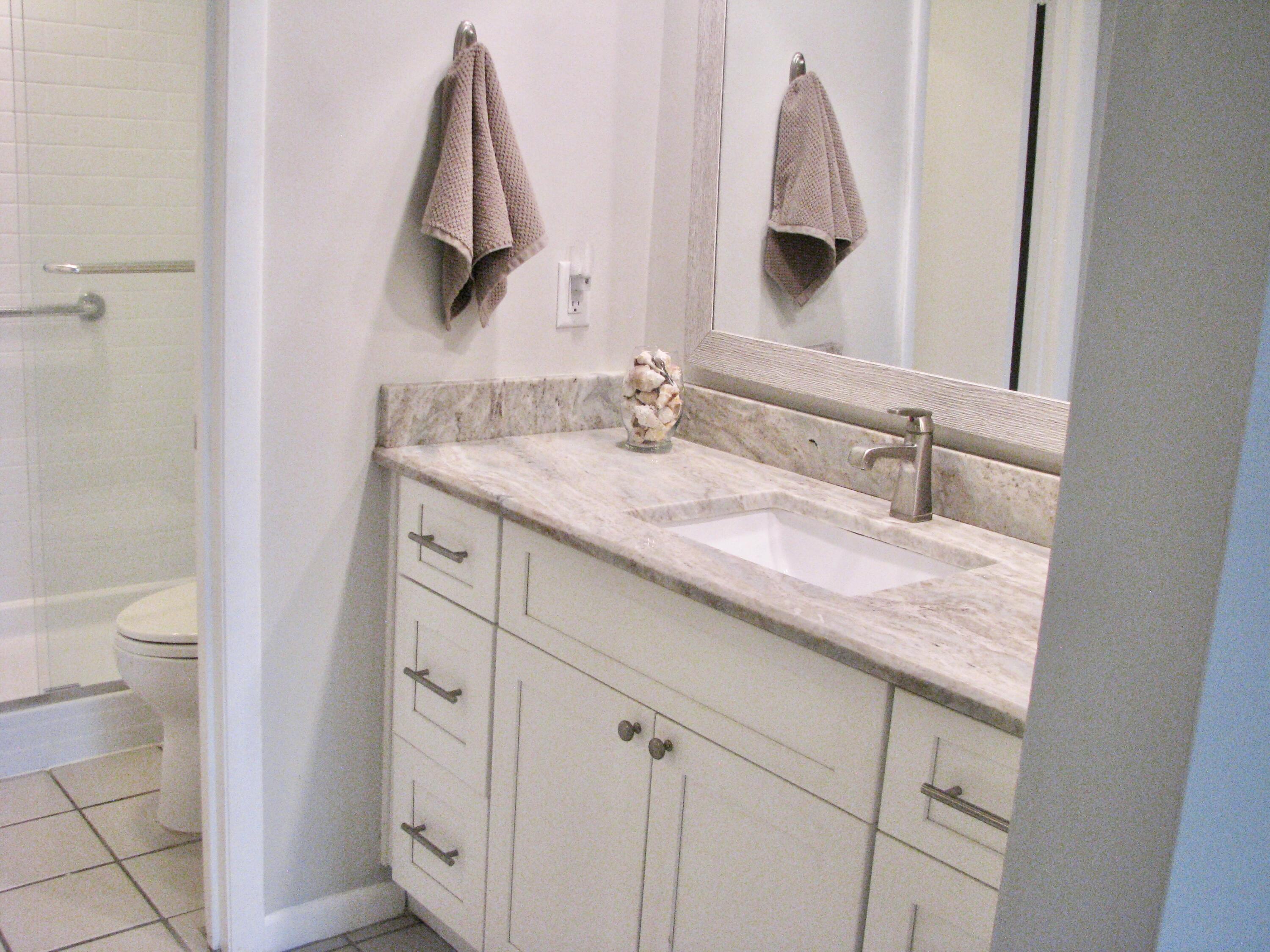 950 South Kanner Highway, Unit D4 Stuart, FL 34994 - Photo 19 of 36 a bathroom with a granite countertop sink and a mirror