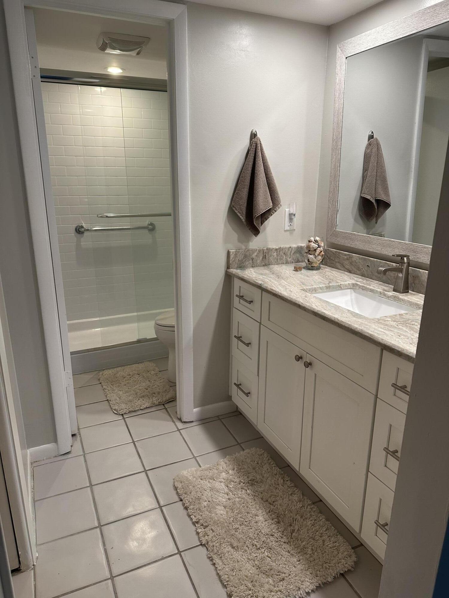 950 South Kanner Highway, Unit D4 Stuart, FL 34994 - Photo 20 of 36 a bathroom with a double vanity sink and mirror