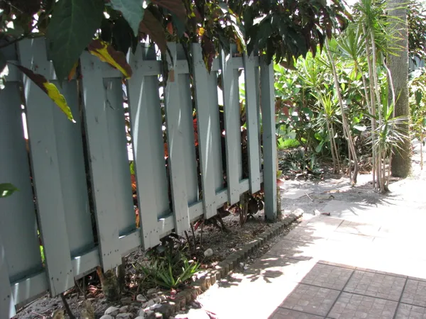 a front view of a house with a yard and fountain