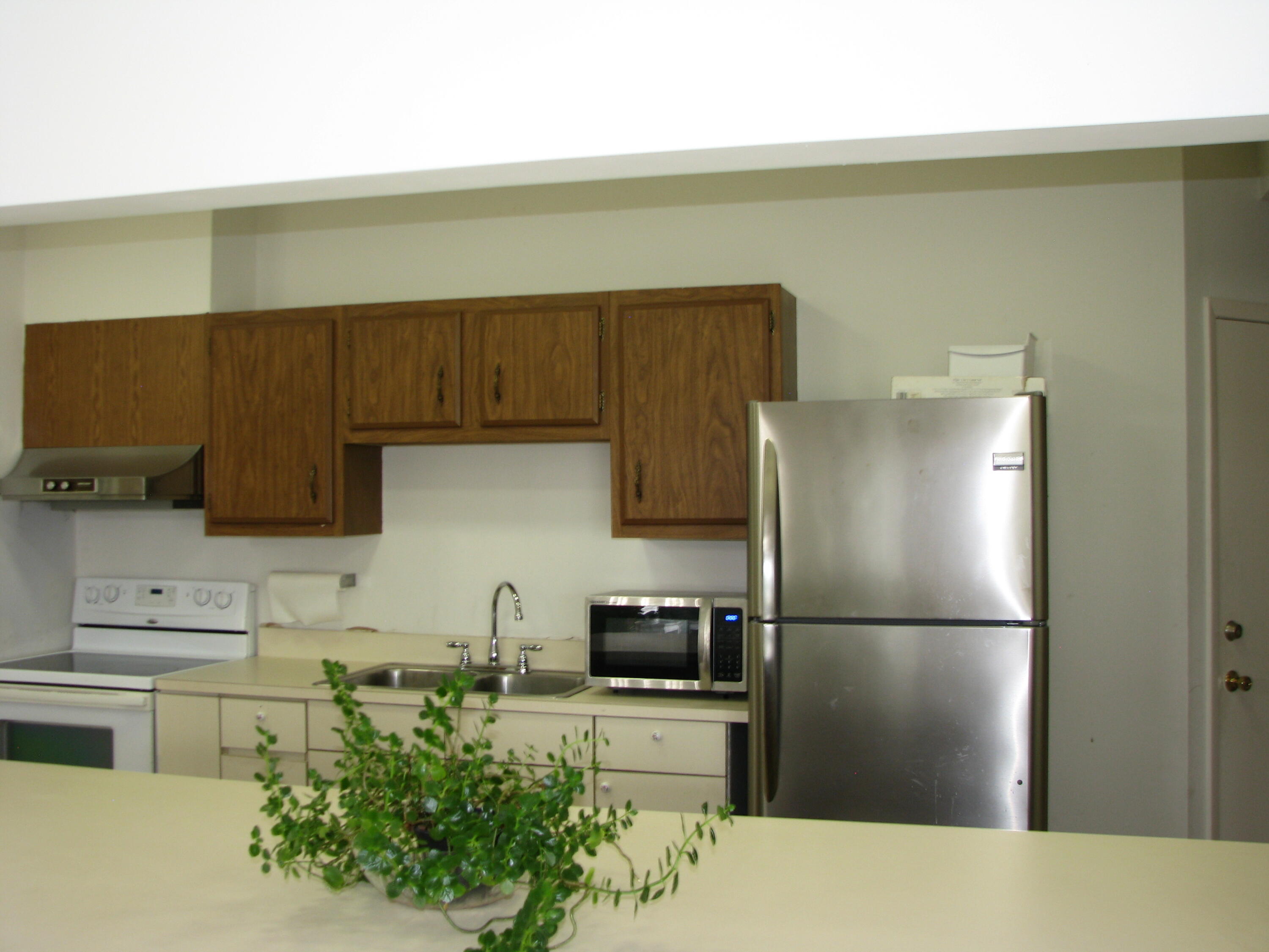 950 South Kanner Highway, Unit D4 Stuart, FL 34994 - Photo 33 of 36 a kitchen with a refrigerator and a sink