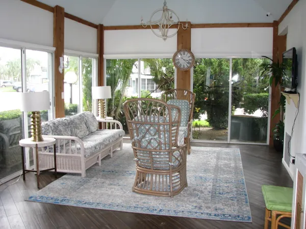 a dining room with wooden floor a glass table and chairs