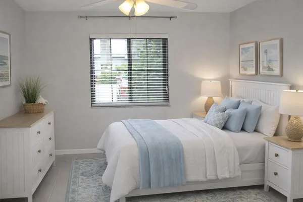 a bedroom with a bed and a window