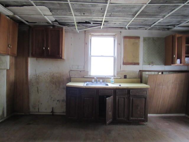 1000 Davis Street Aliquippa, PA 15001 - Photo 6 of 19 a kitchen with a sink and wooden cabinets
