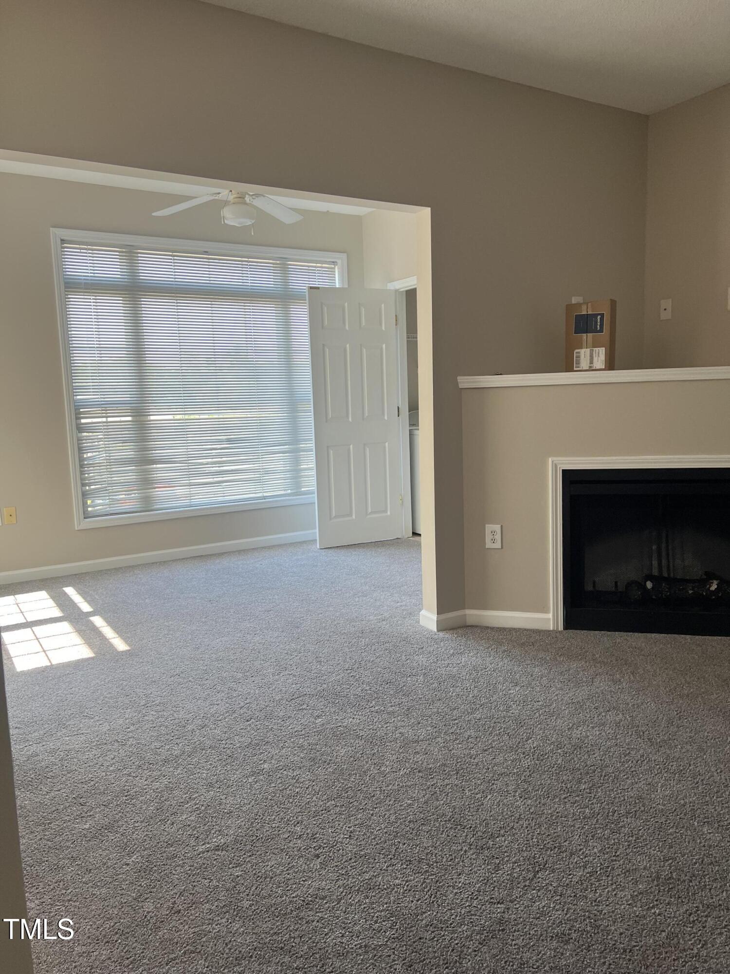 2501 Huntscroft Lane, Unit 200 Raleigh, NC 27617 - Photo 4 of 8 a view of empty room with a fireplace