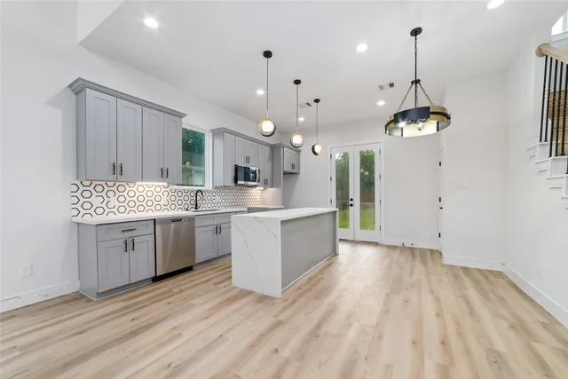 a kitchen with a white kitchen island white cabinets and white appliances
