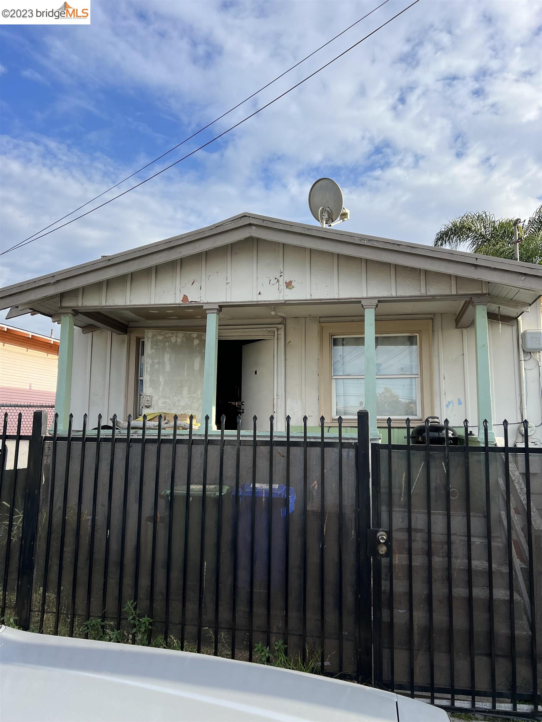 a view of a brick house with wooden fence