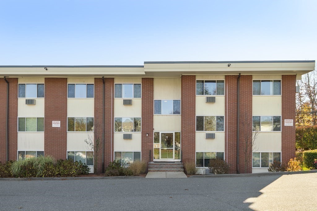 74 Beach Street, Unit 112 Woburn, MA 01801 - Photo 1 of 9 a front view of a building with a entrance