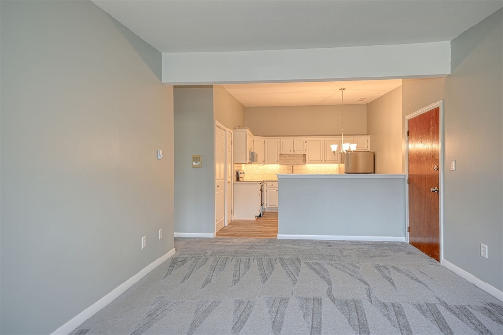 74 Beach Street, Unit 112 Woburn, MA 01801 - Photo 2 of 9 a view of a kitchen cabinets and a room