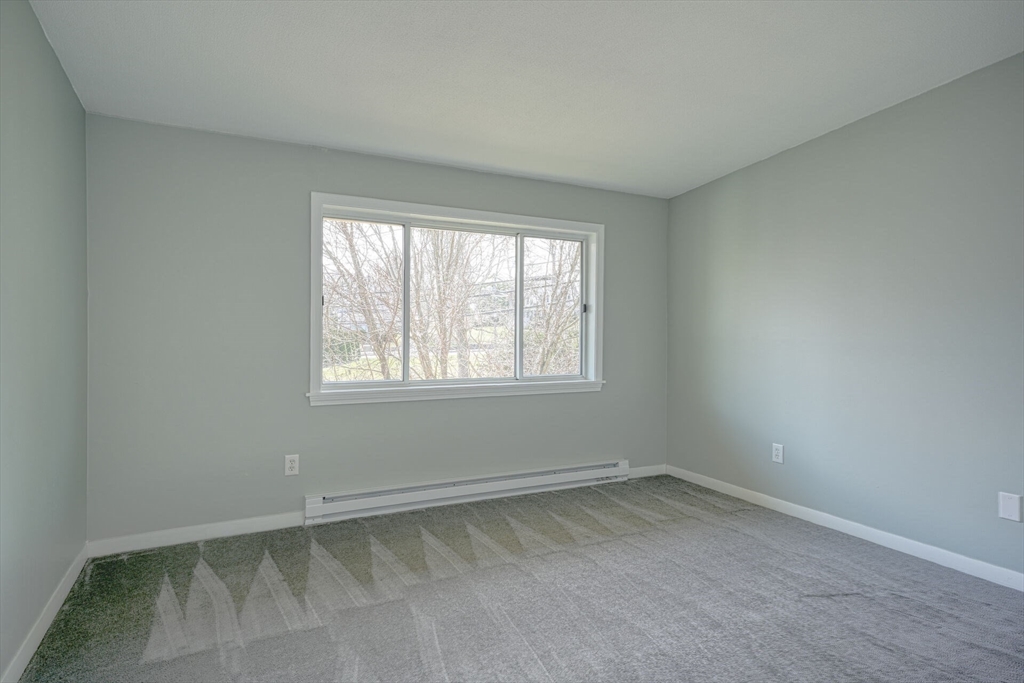 74 Beach Street, Unit 112 Woburn, MA 01801 - Photo 4 of 9 an empty room with a window