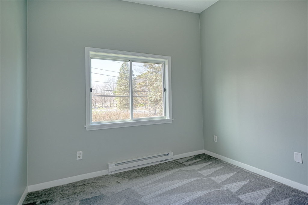 74 Beach Street, Unit 112 Woburn, MA 01801 - Photo 5 of 9 an empty room with a window