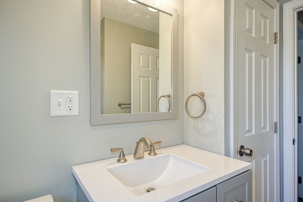 74 Beach Street, Unit 112 Woburn, MA 01801 - Photo 7 of 9 a bathroom with a sink and a mirror