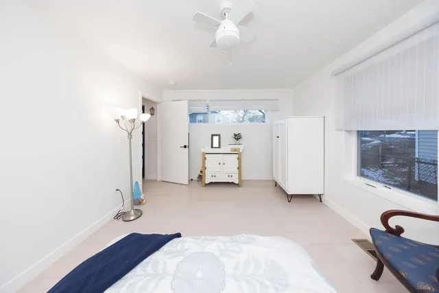 a bedroom with furniture and a potted plant