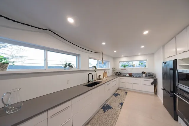 a kitchen with granite countertop stainless steel appliances and wooden cabinets