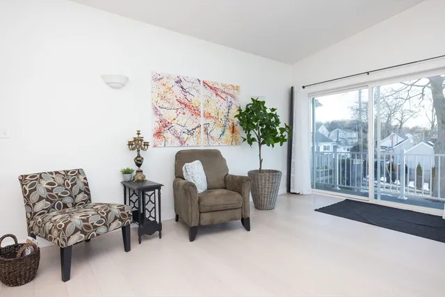 a living room with furniture rug and view of kitchen