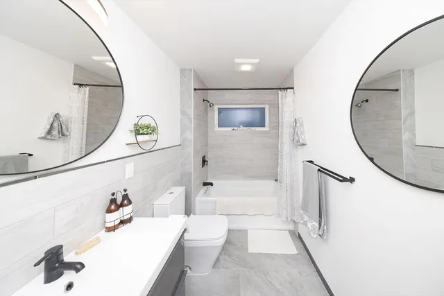 a bathroom with a sink mirror and a mirror
