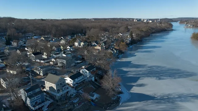 a view of a hallway with white walls and stairs
