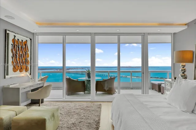 a living room with furniture and a floor to ceiling window