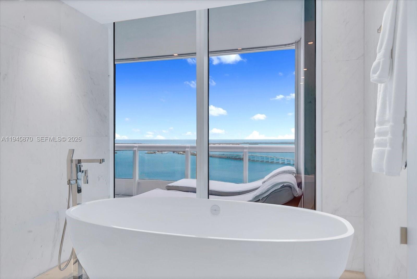 1643 Brickell Avenue, Unit 3904 Miami, FL 33129 - Photo 17 of 26 a bathroom with a sink and mirror