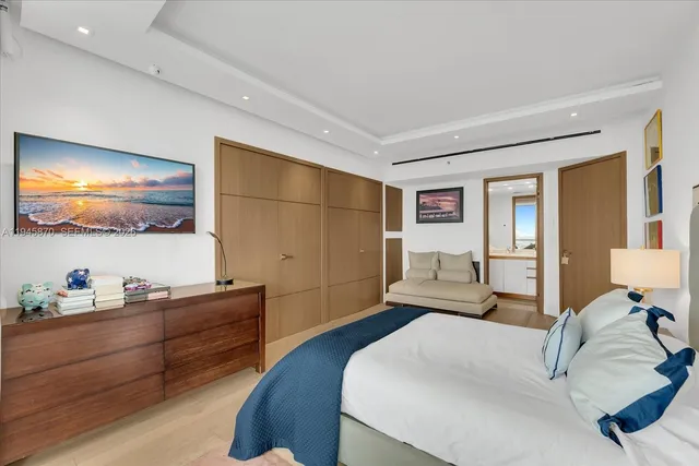 a bedroom with a bed and dresser