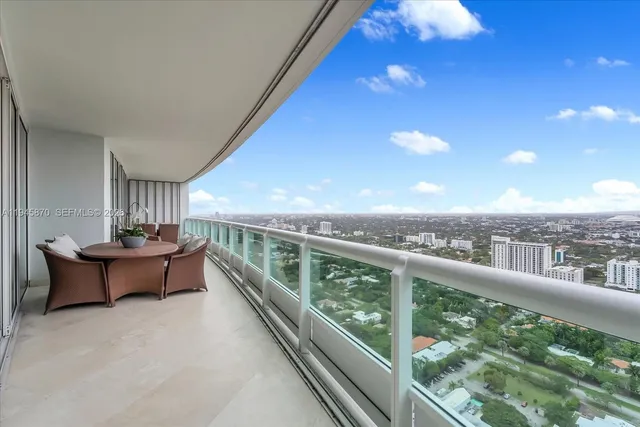 a balcony with furniture and city view