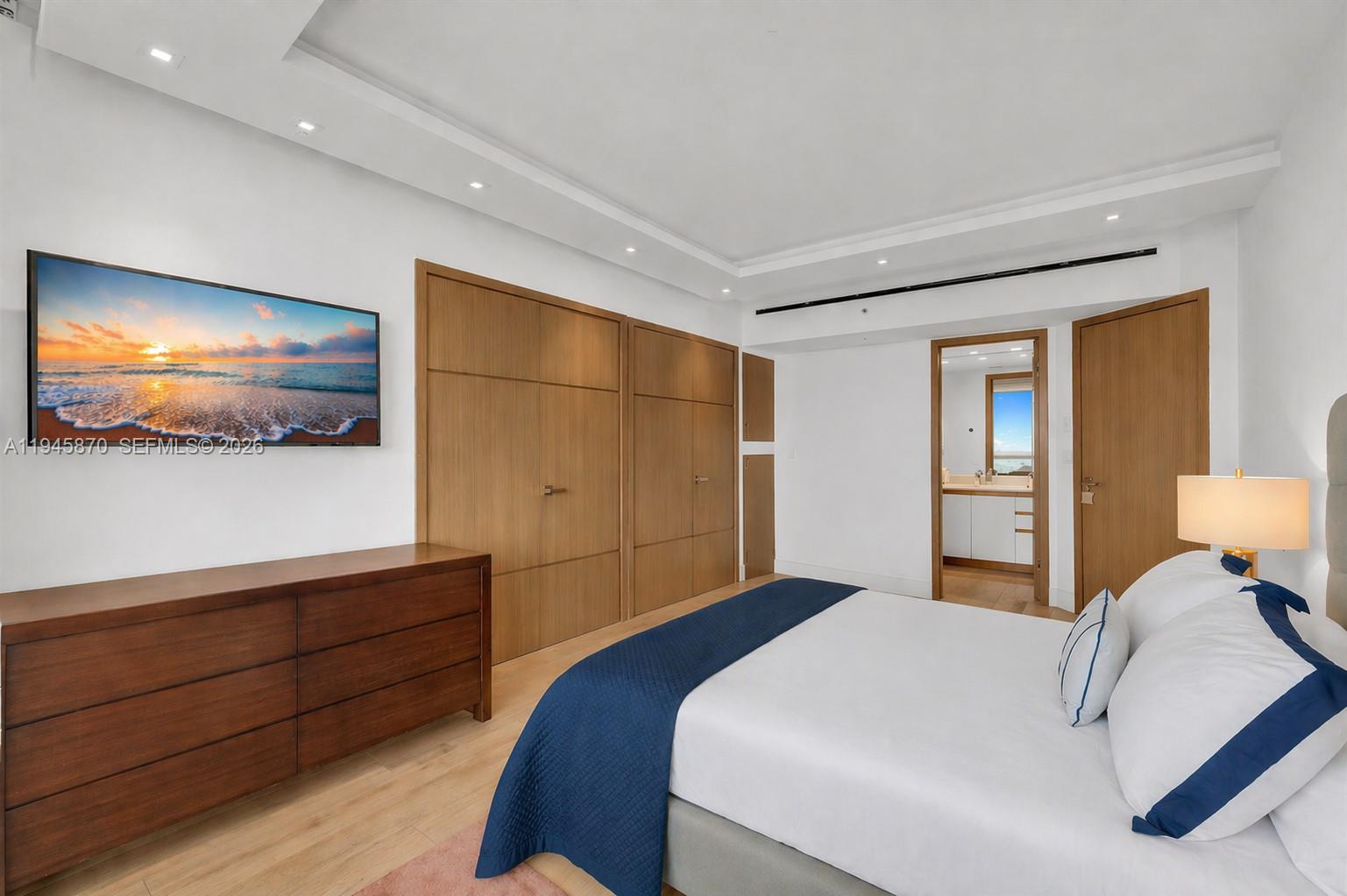 1643 Brickell Avenue, Unit 3904 Miami, FL 33129 - Photo 19 of 26 a bedroom with a bed and a flat screen tv