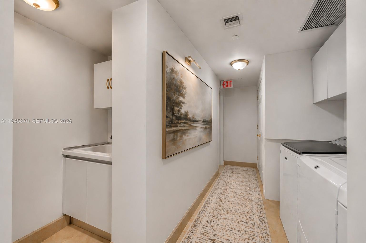 1643 Brickell Avenue, Unit 3904 Miami, FL 33129 - Photo 20 of 26 a hallway with granite countertop white cabinets and white appliances