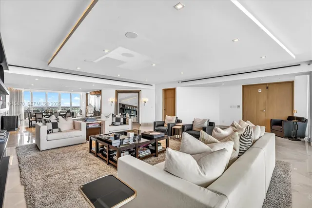 a living room with furniture large window and a table