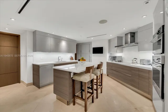 a kitchen with stainless steel appliances kitchen island granite countertop a sink and cabinets