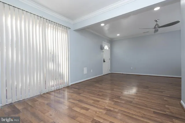 wooden floor in an empty room with a window