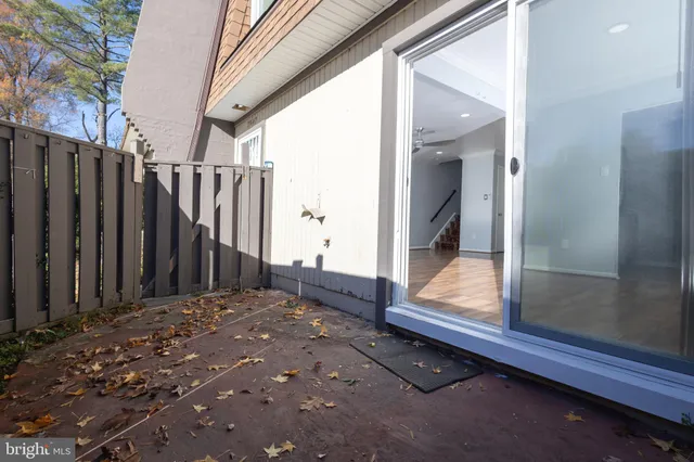 a view of a porch with wooden floor and fence
