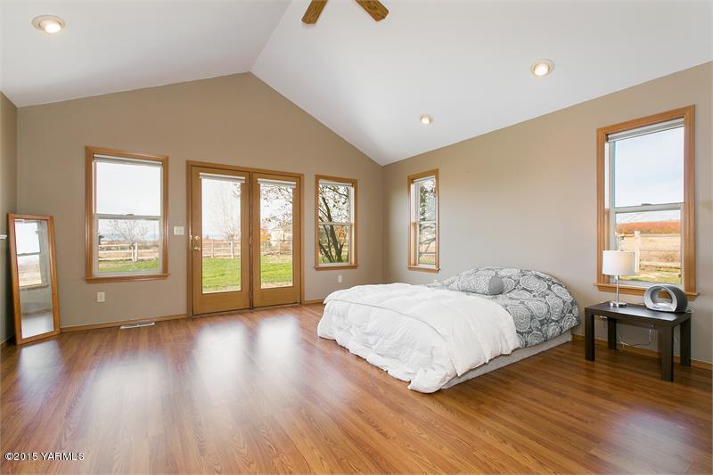 1350 Gilbert Road Zillah, WA 98953 - Photo 11 of 18 a bedroom with a bed and wooden floor