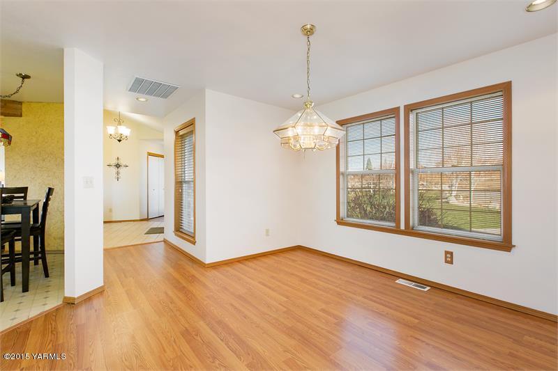 1350 Gilbert Road Zillah, WA 98953 - Photo 10 of 18 a view of an empty room with wooden floor and a window