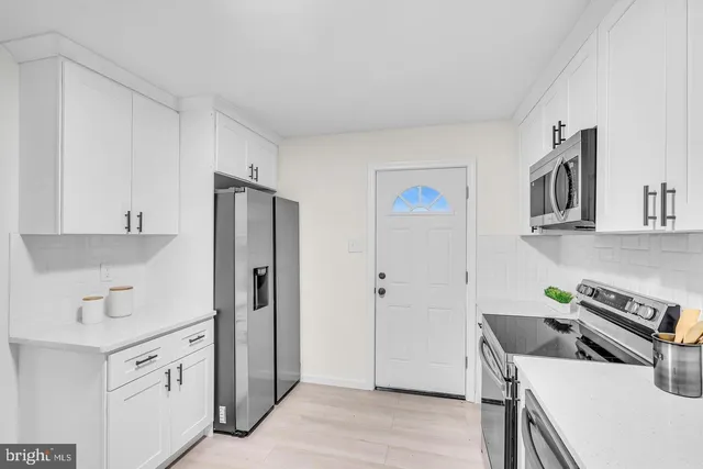 a kitchen with a stove a refrigerator and a sink