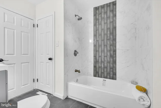 a bathroom with a tub and a shower