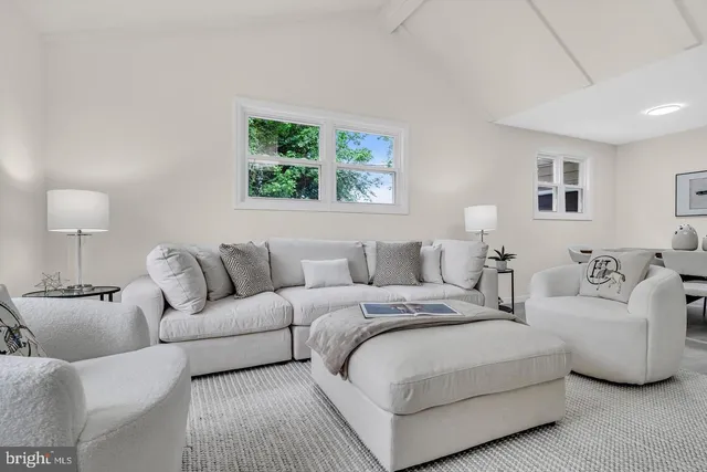 a living room with furniture and a night stand