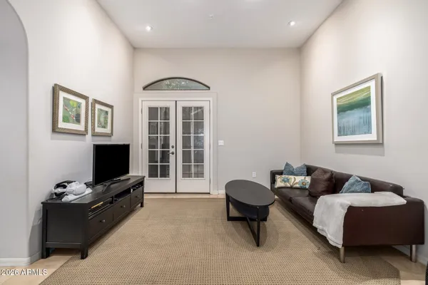 a view of a workspace with furniture and a window