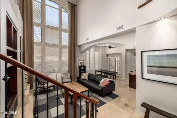 a spacious bedroom with a bed and a large window